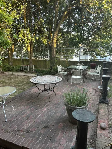 a view of a backyard with sitting area