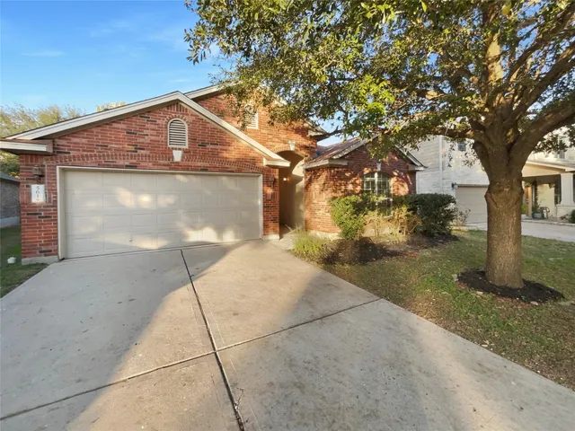 a view of a house with a tree