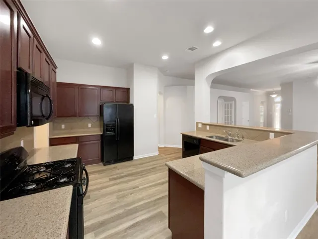 a kitchen with stainless steel appliances a sink and a stove