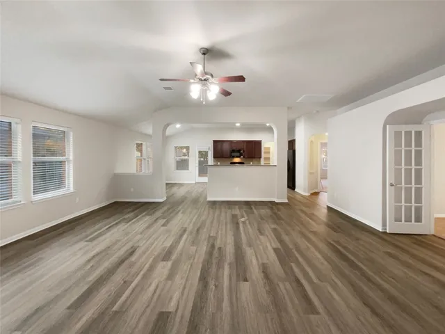 a view of a big room with wooden floor windows and fireplace