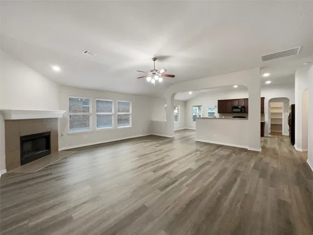 a view of a livingroom with a fireplace a sink and dishwasher kitchen view