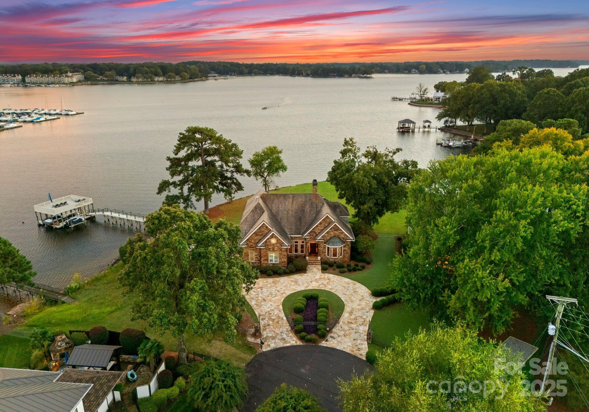 a aerial view of a house with outdoor space and lake view