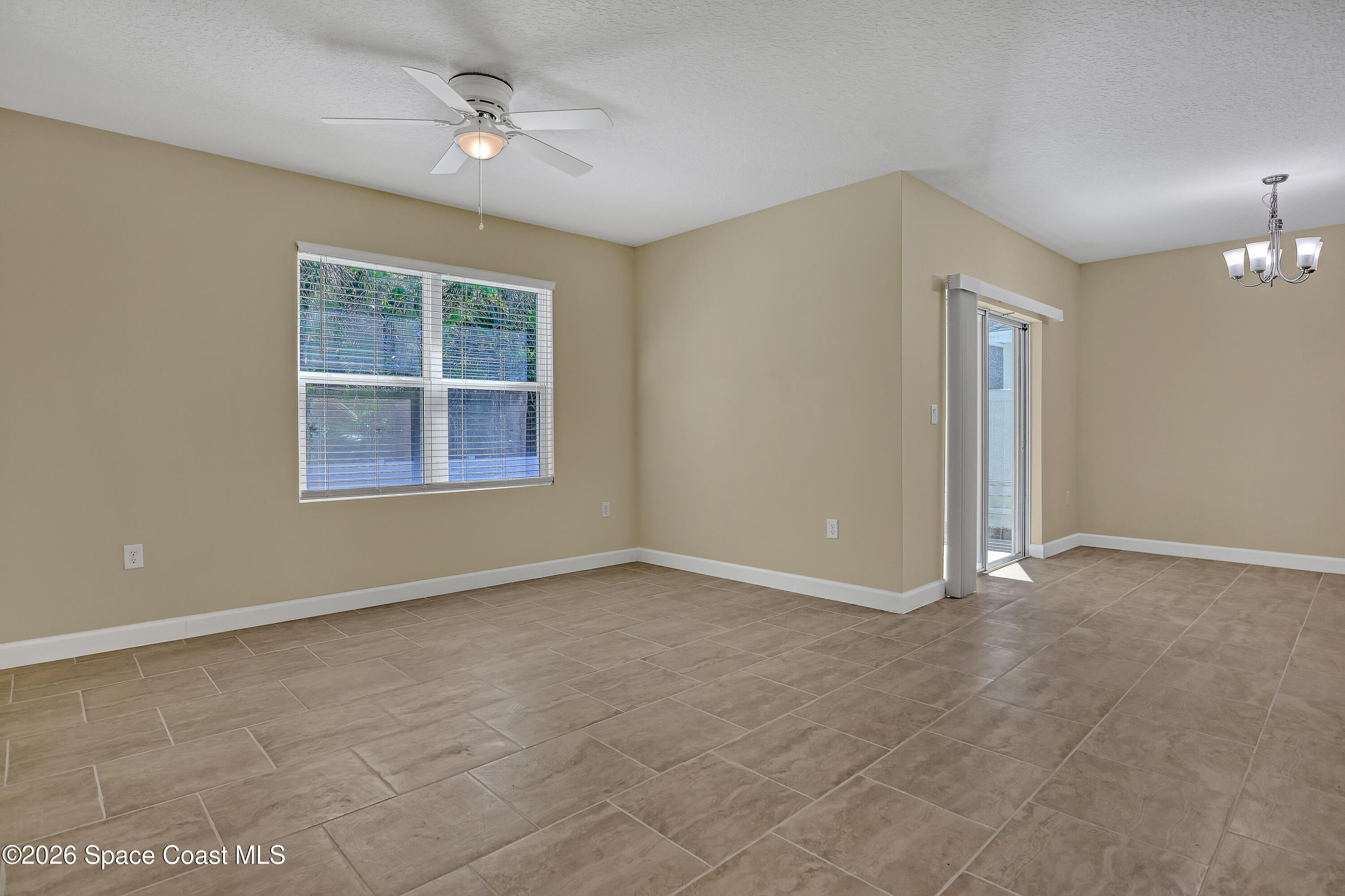 2605 Falcon Lane Mims, FL 32754 - Photo 11 of 29 an empty room with windows and ceiling fan