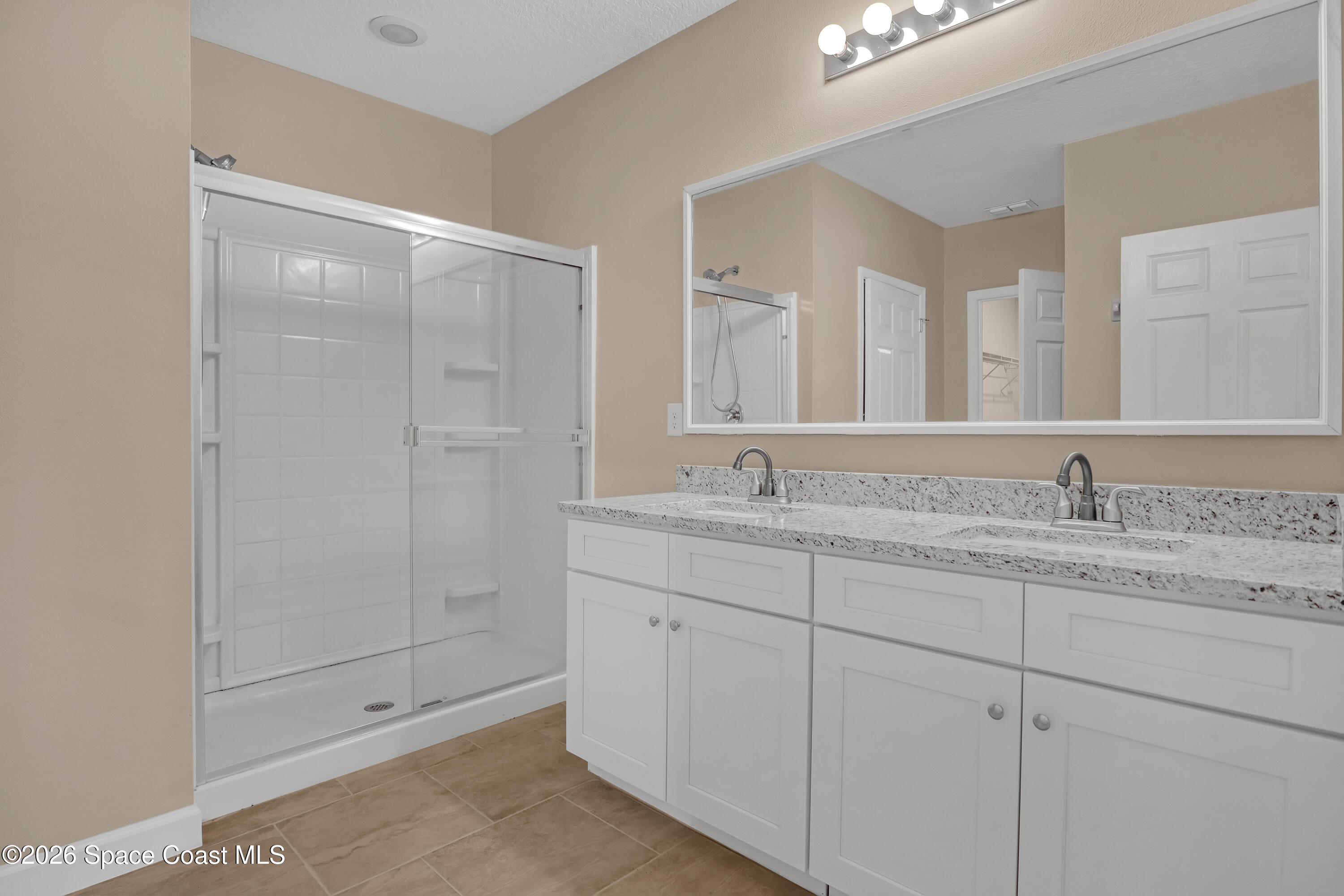 2605 Falcon Lane Mims, FL 32754 - Photo 16 of 29 a bathroom with a shower sink and mirror