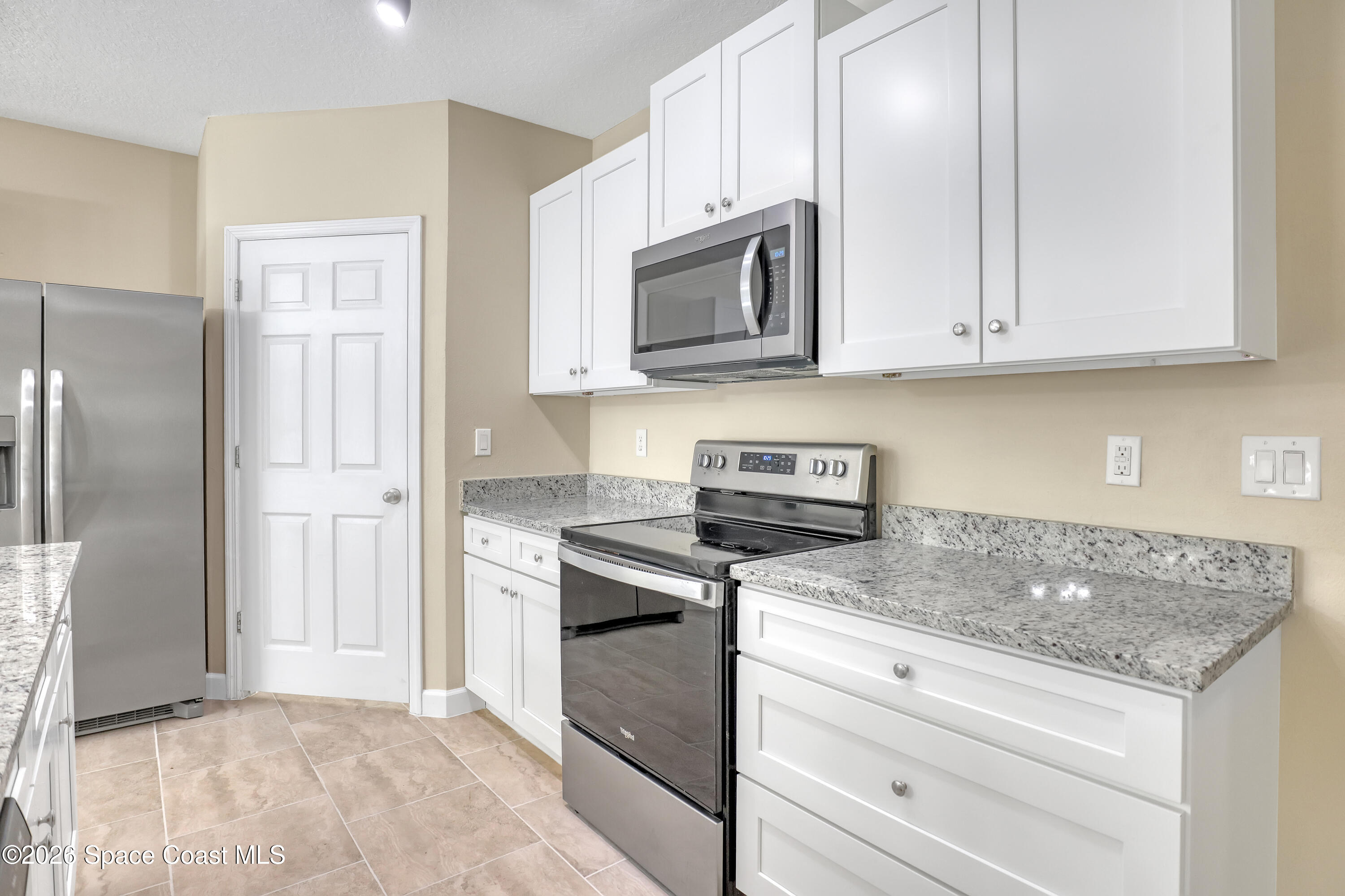 2605 Falcon Lane Mims, FL 32754 - Photo 7 of 29 a kitchen with stainless steel appliances granite countertop white cabinets and a stove