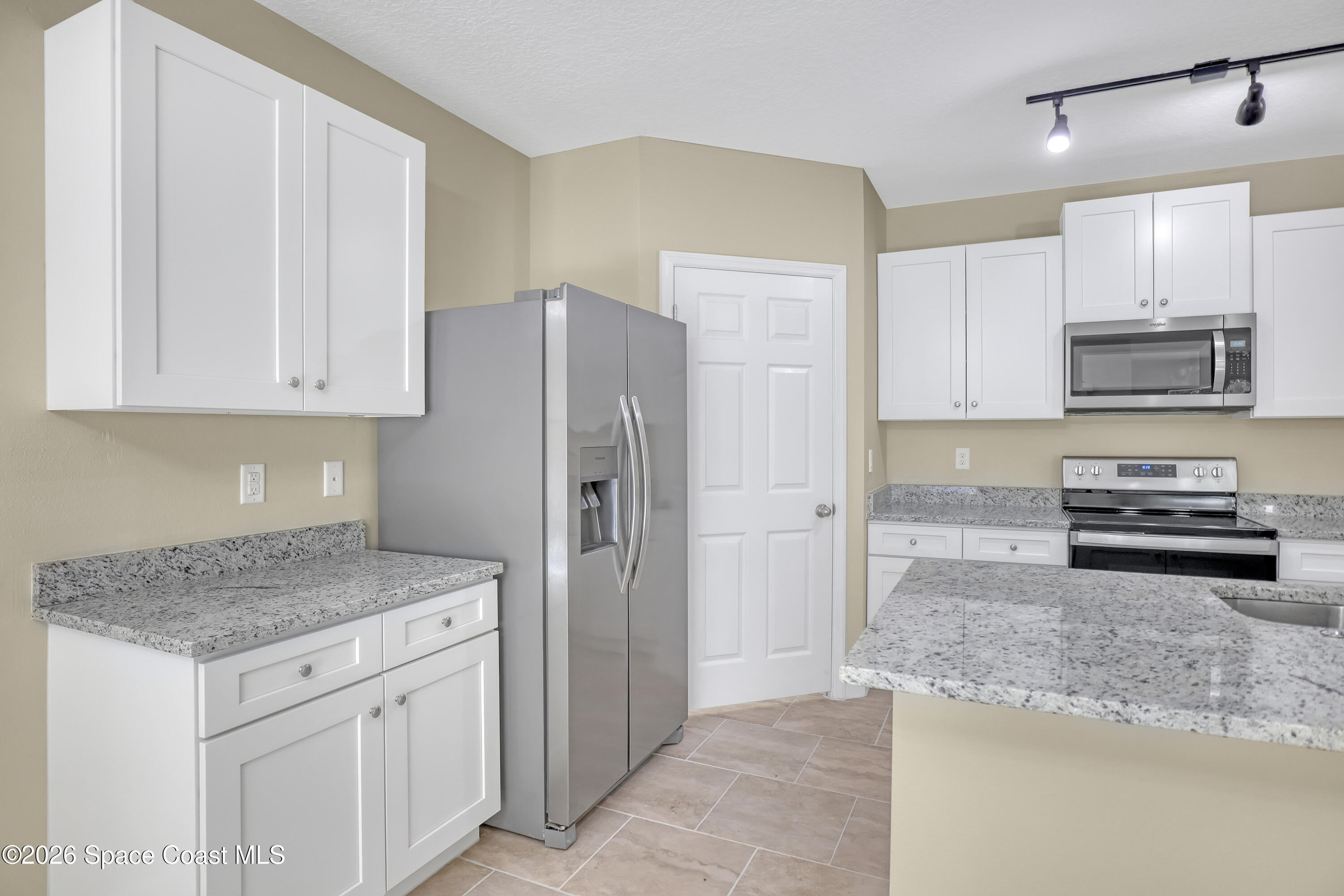 2605 Falcon Lane Mims, FL 32754 - Photo 8 of 29 a kitchen with stainless steel appliances granite countertop a refrigerator and a stove