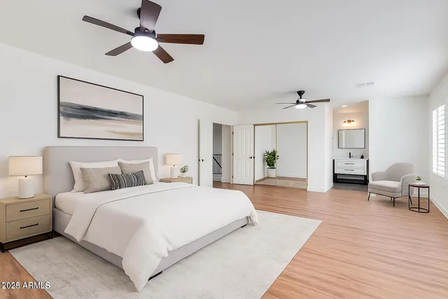 an empty room with wooden floor ceiling fan and window
