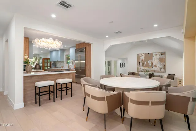 a dining room with furniture and large windows