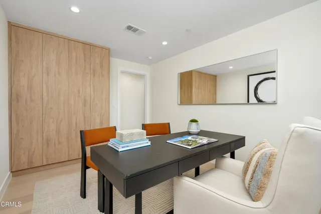 a bathroom with a sink and mirror with toilet