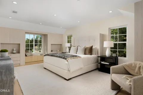 a bedroom with a bed and a large window