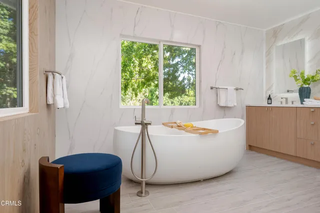 a bathroom with a double vanity sink and mirror with shower
