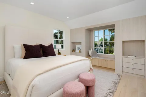 a view of backyard with large trees and plants