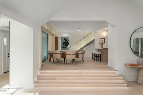 a kitchen with counter top space a sink wooden floor and stainless steel appliances