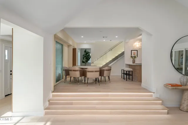 a kitchen with counter top space a sink wooden floor and stainless steel appliances