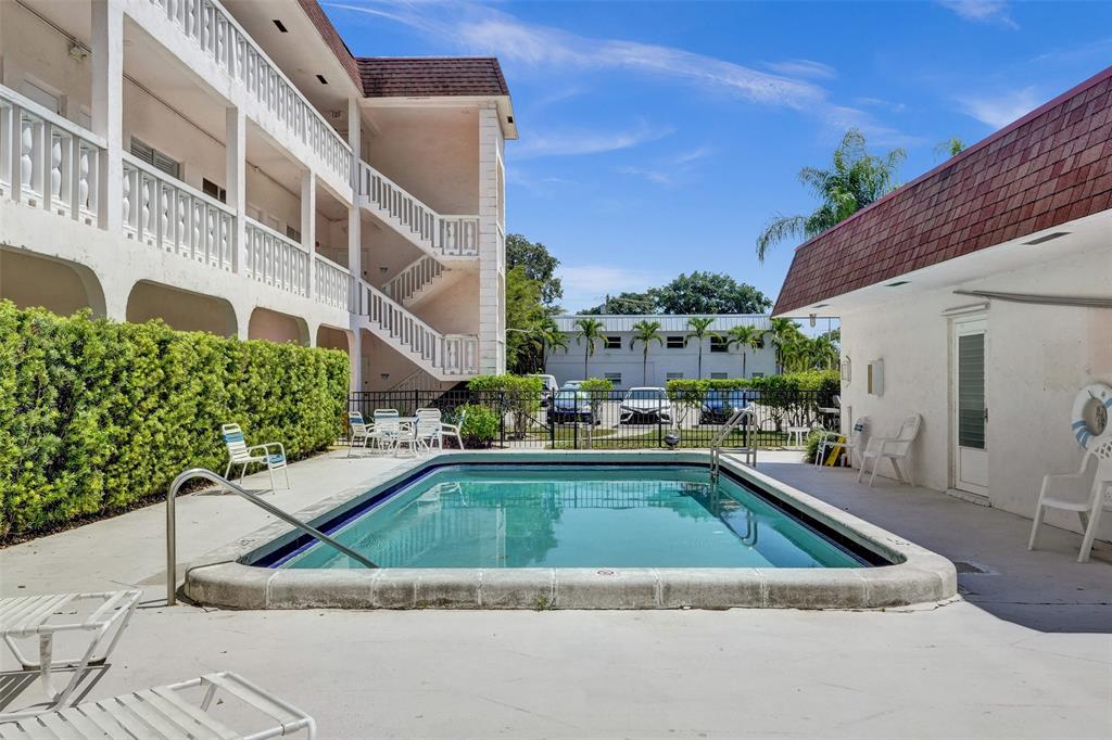 601 Southeast 5th Court, Unit 309 Fort Lauderdale, FL 33301 - Photo 2 of 17 a view of a house with pool and chairs