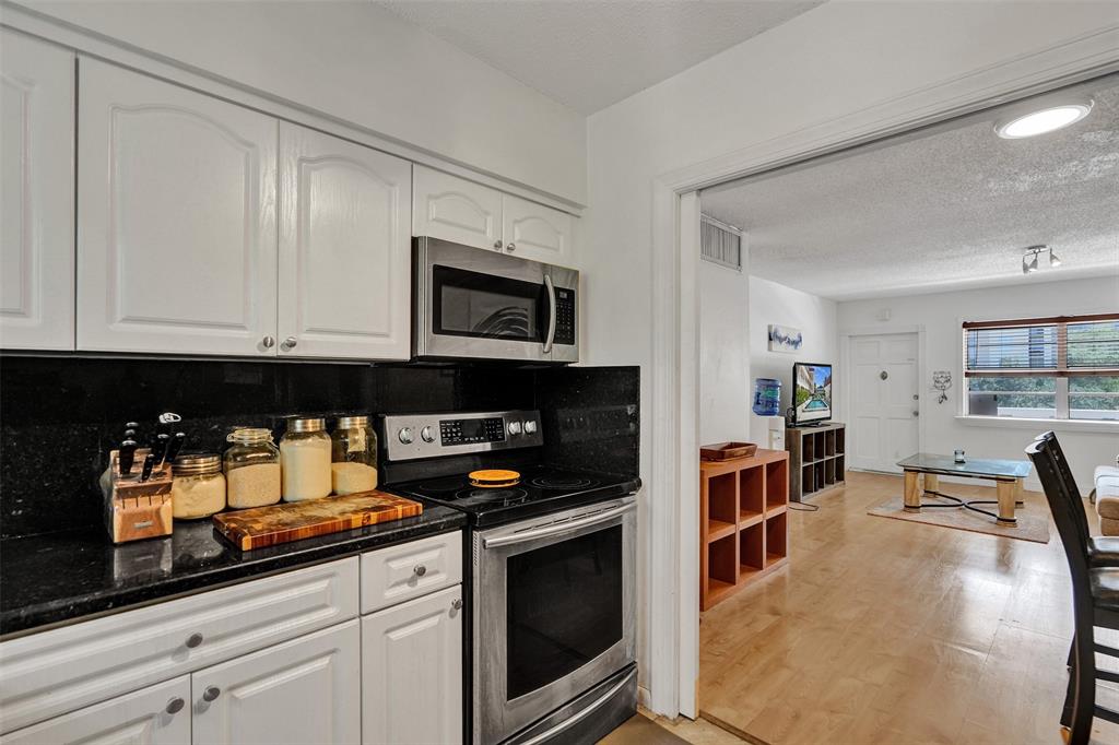 601 Southeast 5th Court, Unit 309 Fort Lauderdale, FL 33301 - Photo 9 of 17 a kitchen with stainless steel appliances granite countertop a stove and cabinets