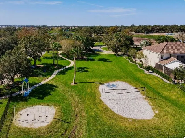 an aerial view of a house with a garden and lake view