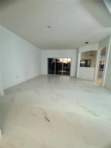 an empty room with furniture and window