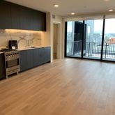 a view of an empty room with a kitchen