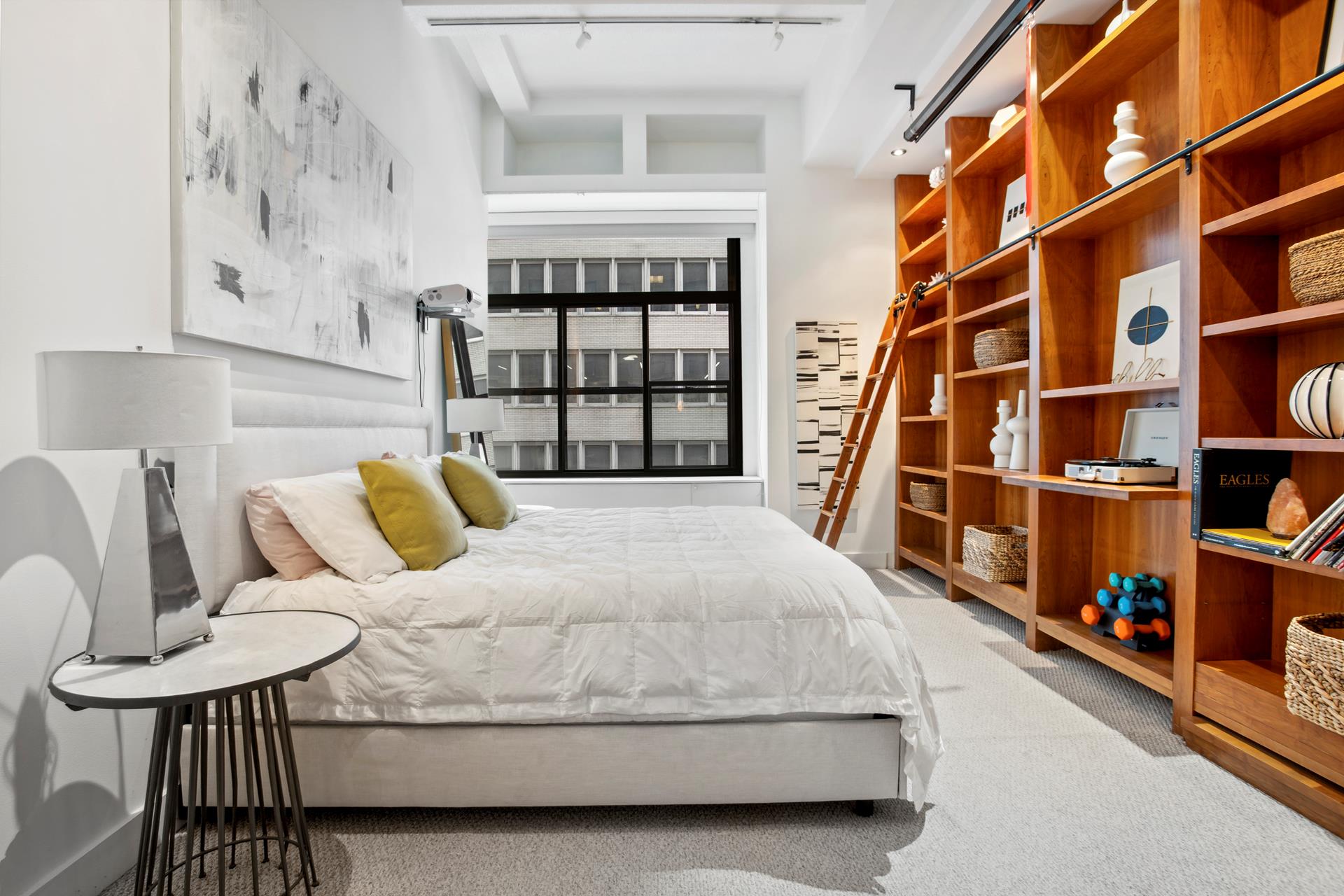 a bedroom with a bed furniture and a book shelf