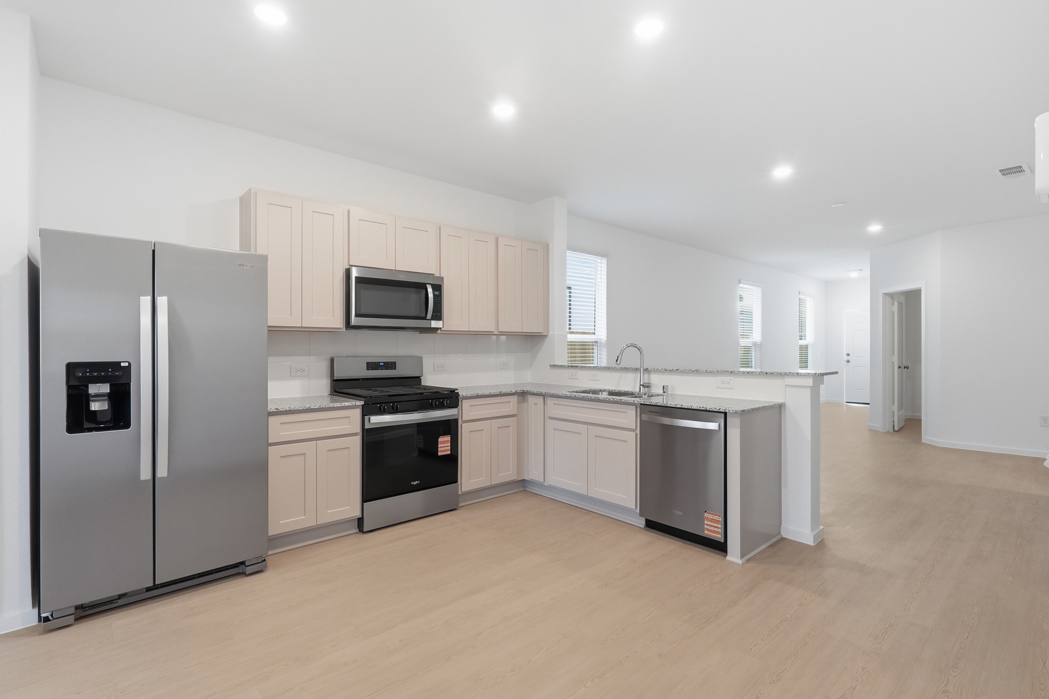 26299 Arrowleaf Drive Magnolia, TX 77355 - Photo 11 of 24 a kitchen with a refrigerator stove a sink and a microwave