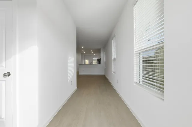 a view of a hallway with windows