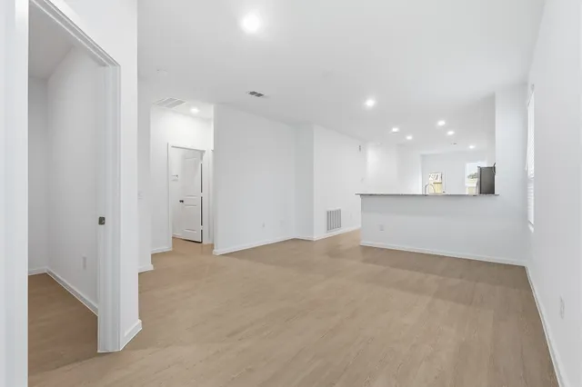 a view of a kitchen with a sink and a refrigerator