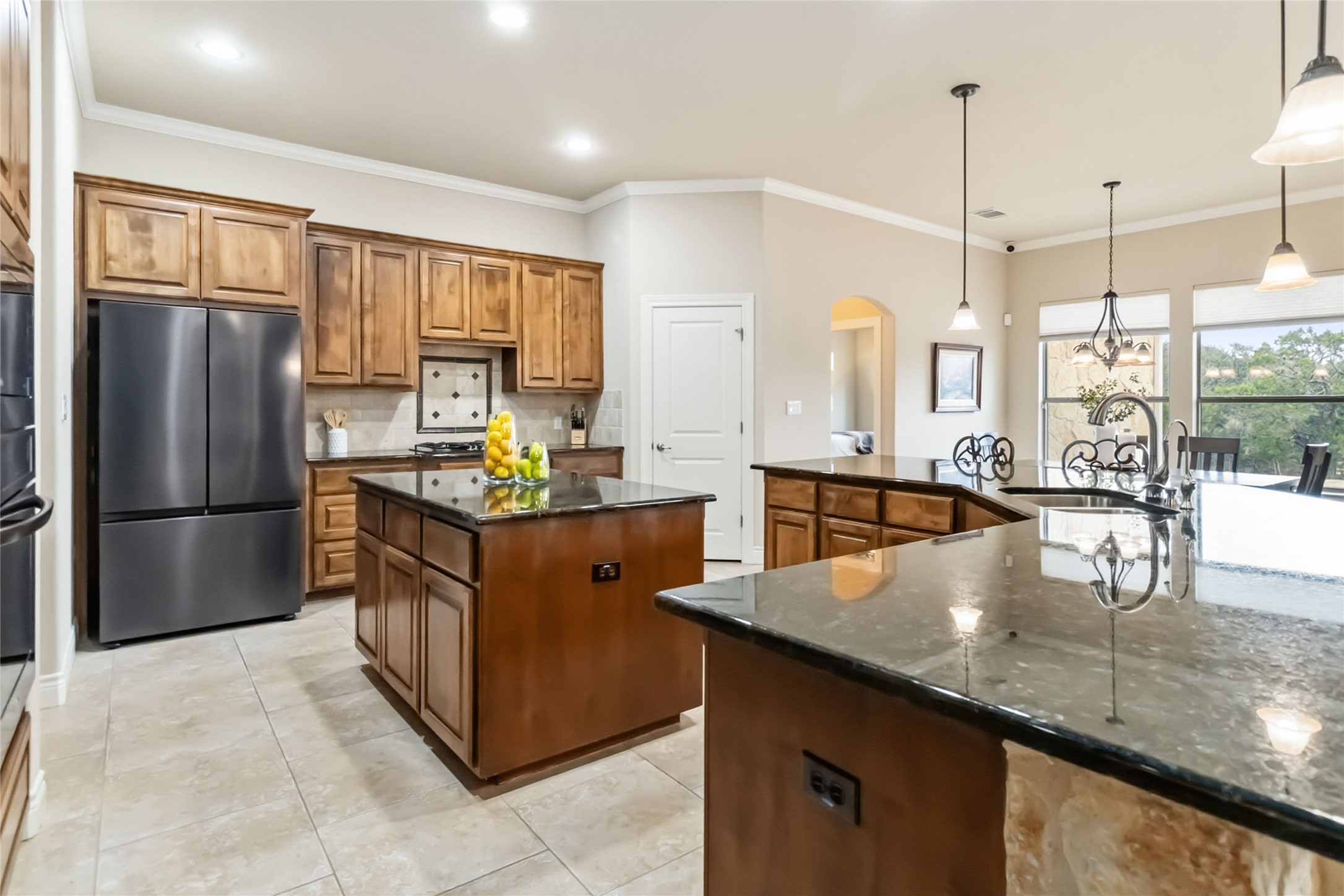 108 Standing Oak Drive Georgetown, TX 78633 - Photo 11 of 37 Alternate view of the expansive kitchen highlighting dual granite islands, custom cabinetry, and abundant workspace.