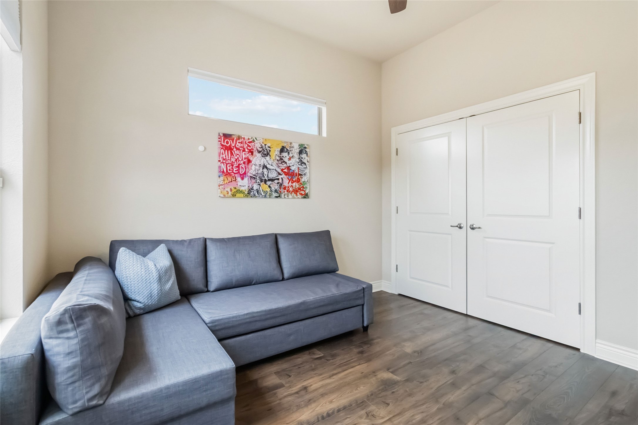 108 Standing Oak Drive Georgetown, TX 78633 - Photo 30 of 37 Bedroom three offers a comfortable layout with neutral tones, wood flooring, ceiling fan, and generous natural light. Ideal for a bedroom, guest space, or bonus room with plenty of flexibility.