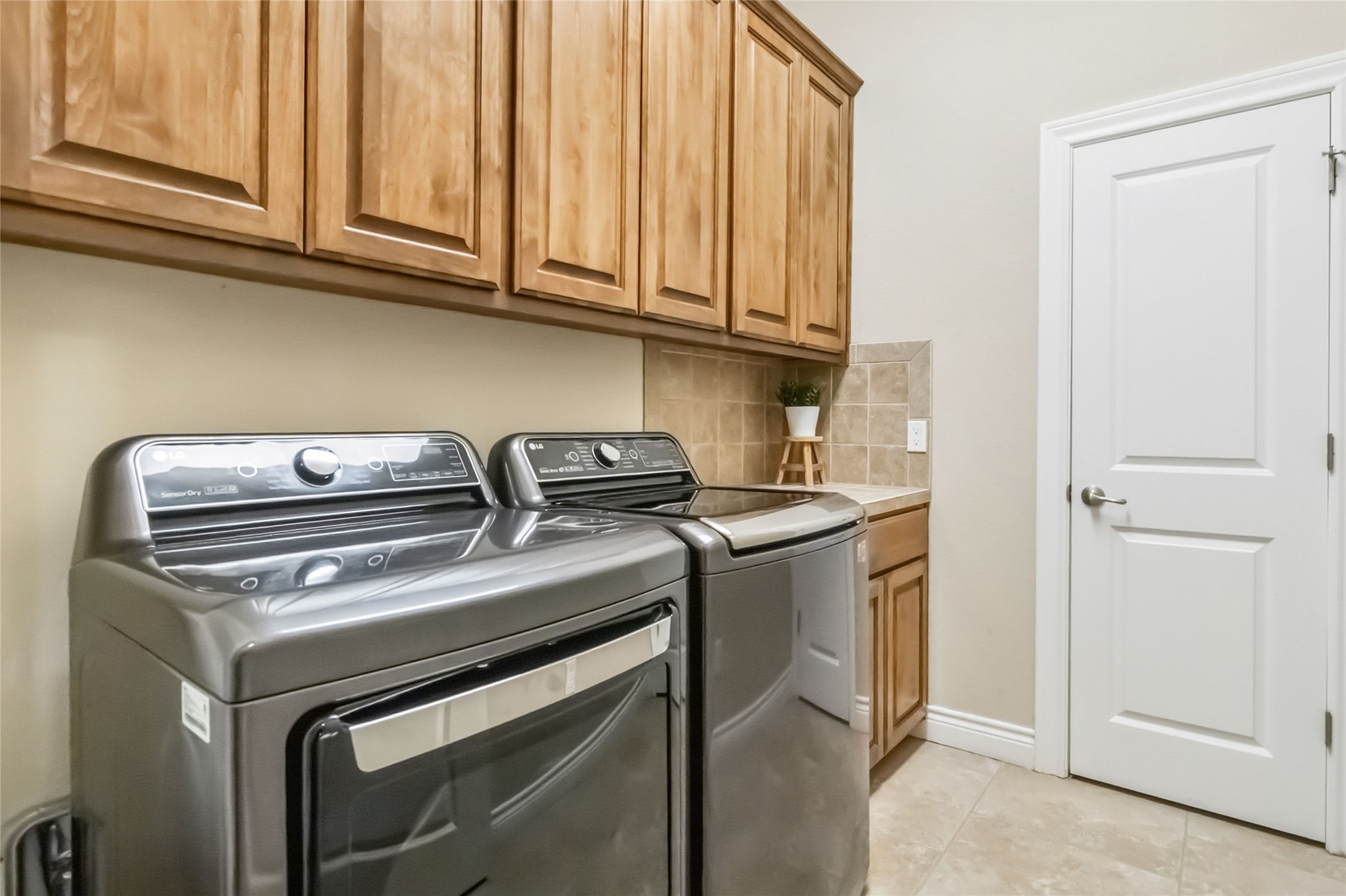 108 Standing Oak Drive Georgetown, TX 78633 - Photo 31 of 37 Dedicated laundry room with upper and lower cabinetry, counter space for folding, and room for full-size washer and dryer.
