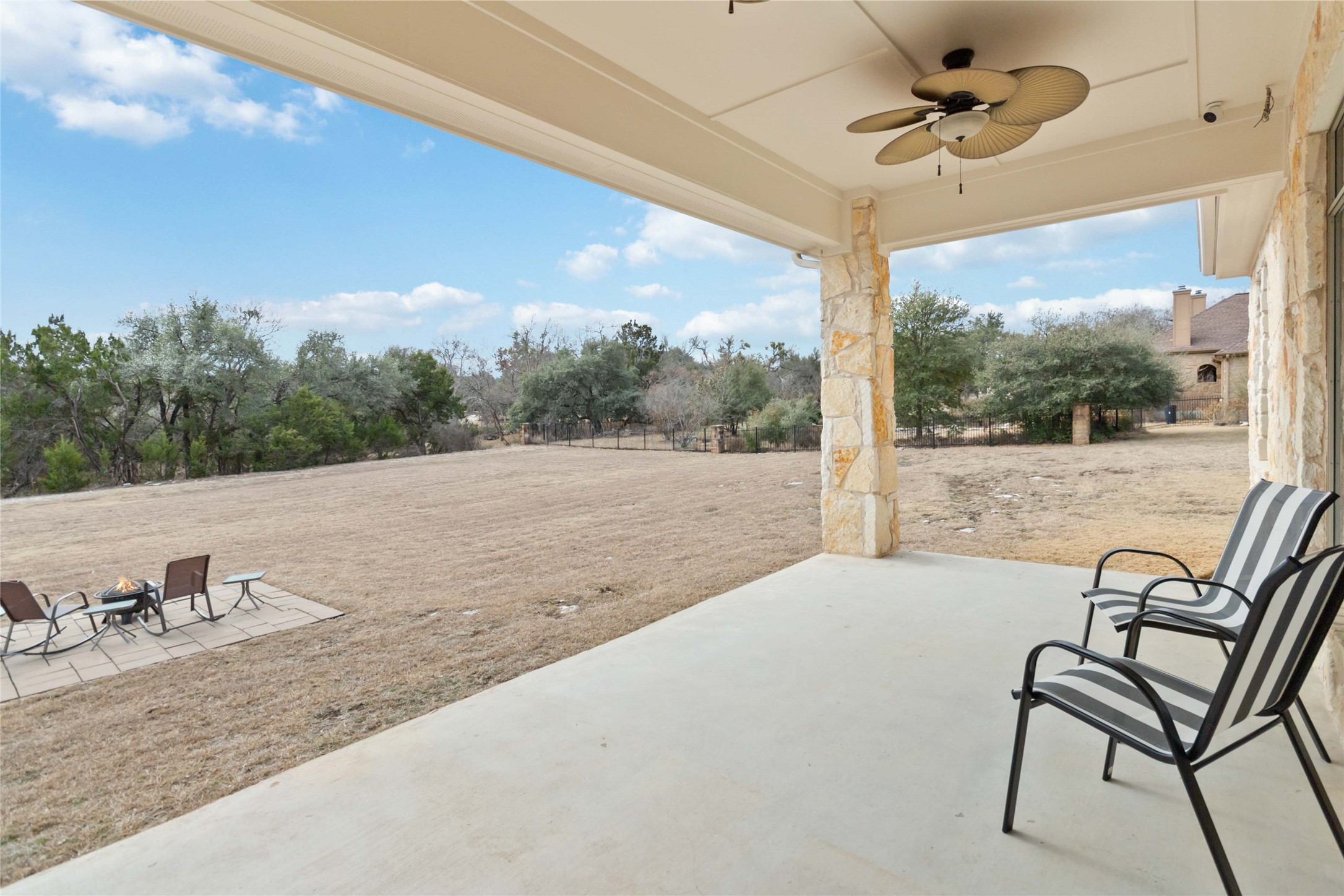 108 Standing Oak Drive Georgetown, TX 78633 - Photo 34 of 37 This angle showcases the generous covered patio and sweeping backyard beyond, giving a clear sense of the privacy and usable outdoor space.