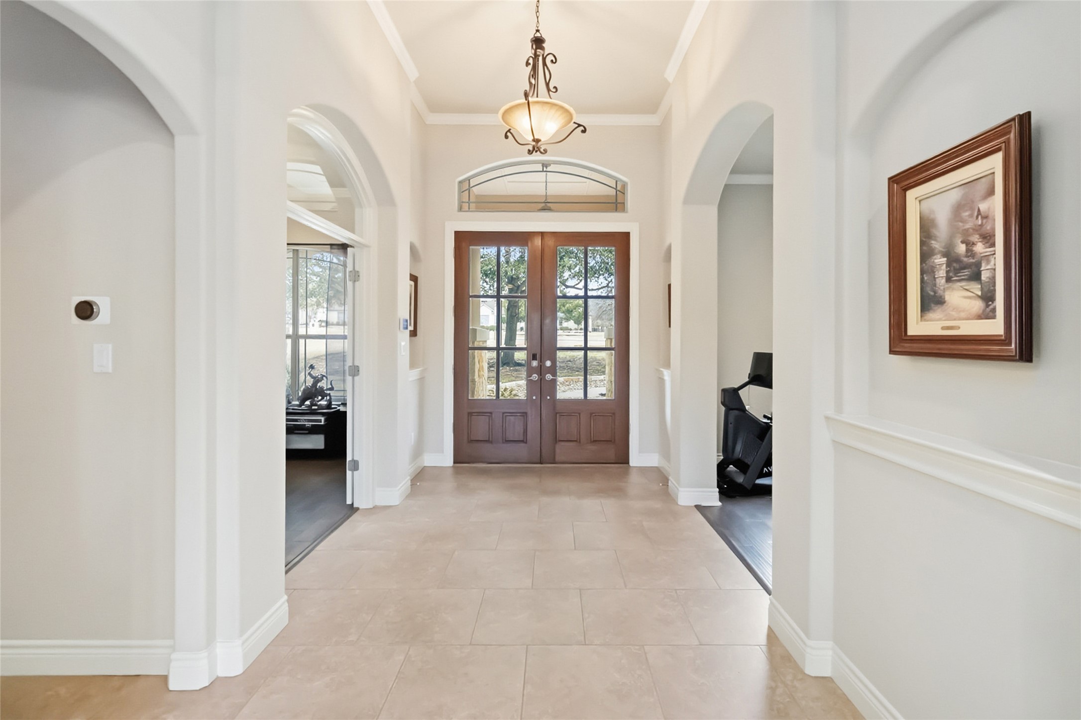 108 Standing Oak Drive Georgetown, TX 78633 - Photo 6 of 37 The front foyer features elegant archways, neutral tile flooring, and double glass doors that create a bright, open first impression.