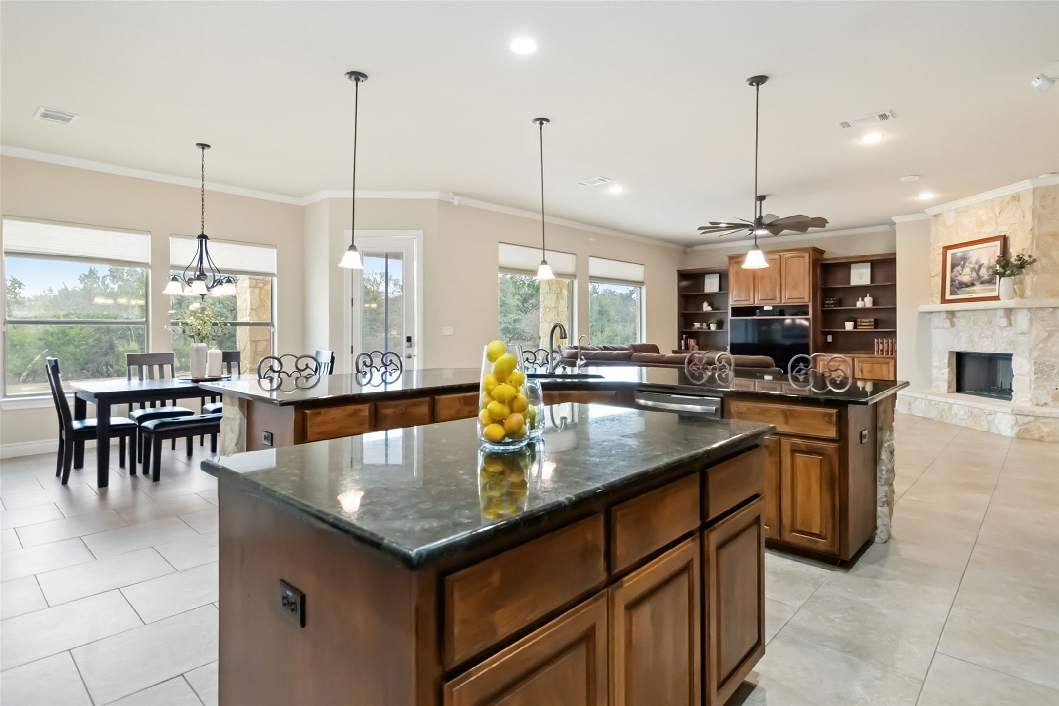 108 Standing Oak Drive Georgetown, TX 78633 - Photo 10 of 37 Open kitchen with dual granite islands, custom cabinetry, and effortless flow to dining and living areas.
