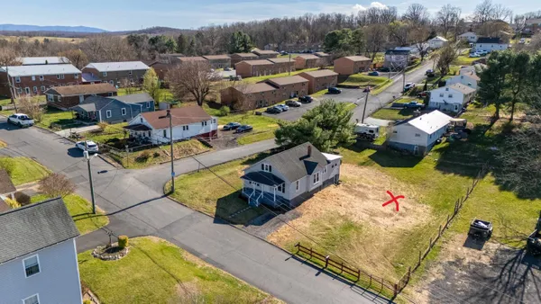 an aerial view of a houses with yard