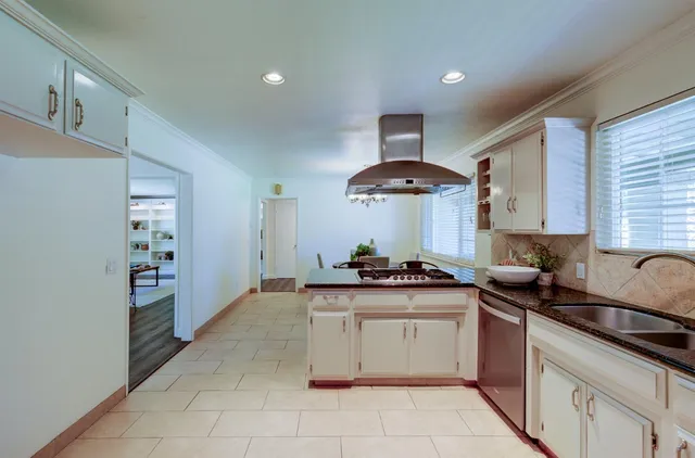 a kitchen with a stove and a sink