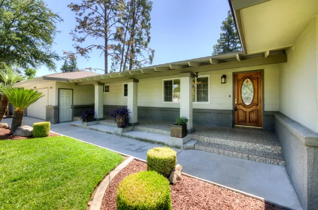 a front view of a house with garden