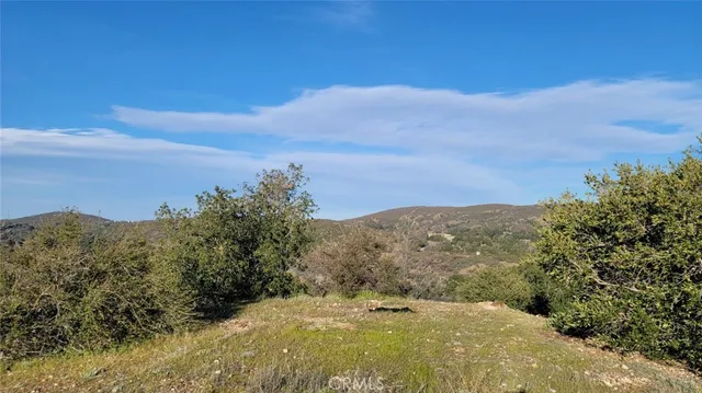 a view of mountain with mountains in the background