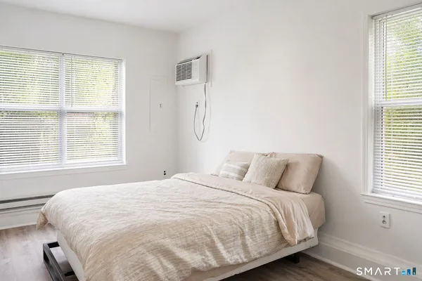 a bedroom with a bed and a window
