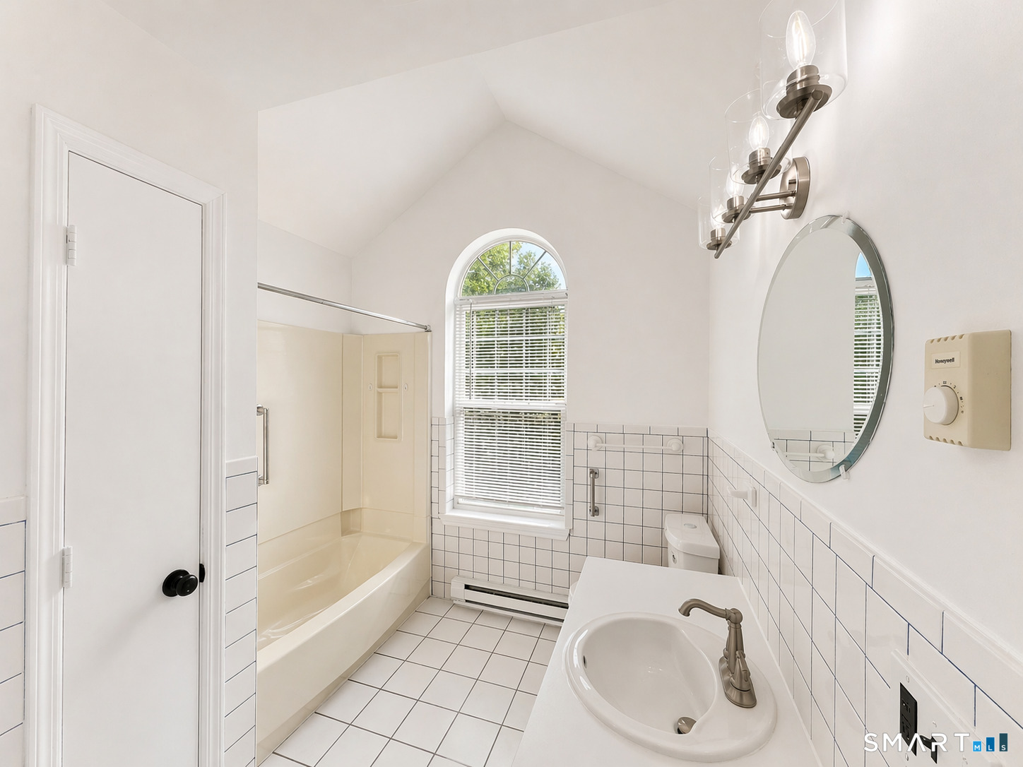 905 Oronoke Road, Unit 13 Waterbury, CT 06708 - Photo 16 of 18 a bathroom with a sink a vanity and a mirror