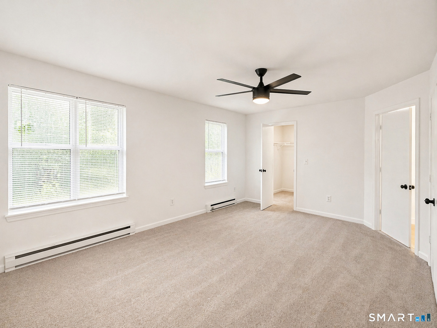 905 Oronoke Road, Unit 13 Waterbury, CT 06708 - Photo 18 of 18 an empty room with windows and ceiling fan