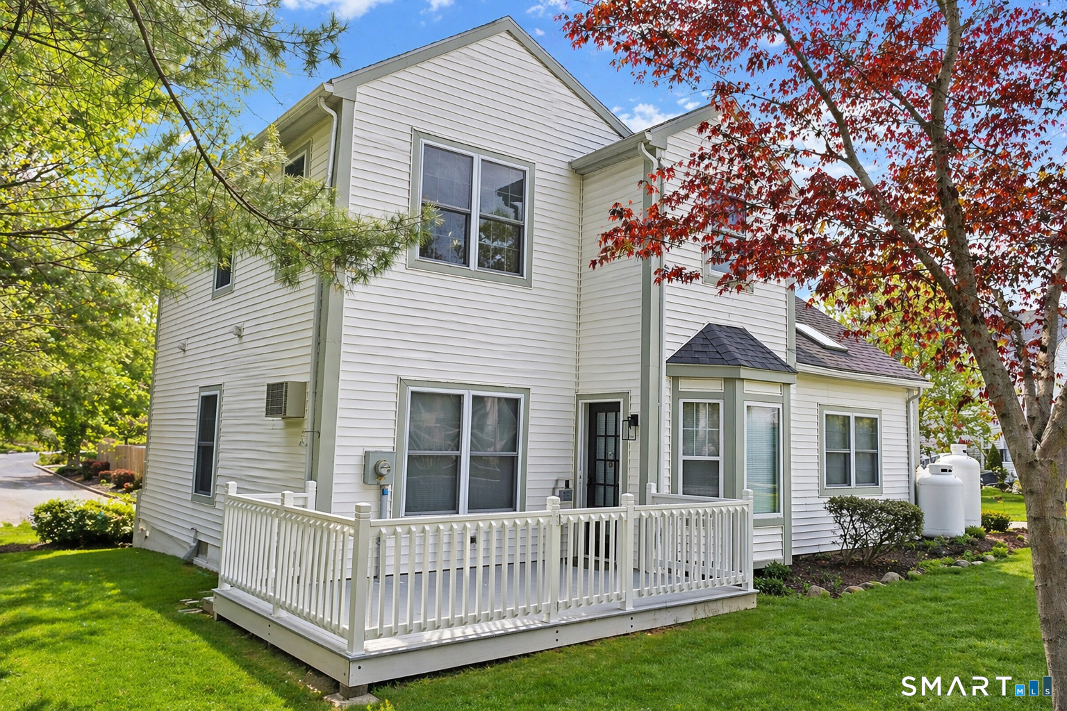 905 Oronoke Road, Unit 13 Waterbury, CT 06708 - Photo 2 of 18 a view of a house with a yard and deck