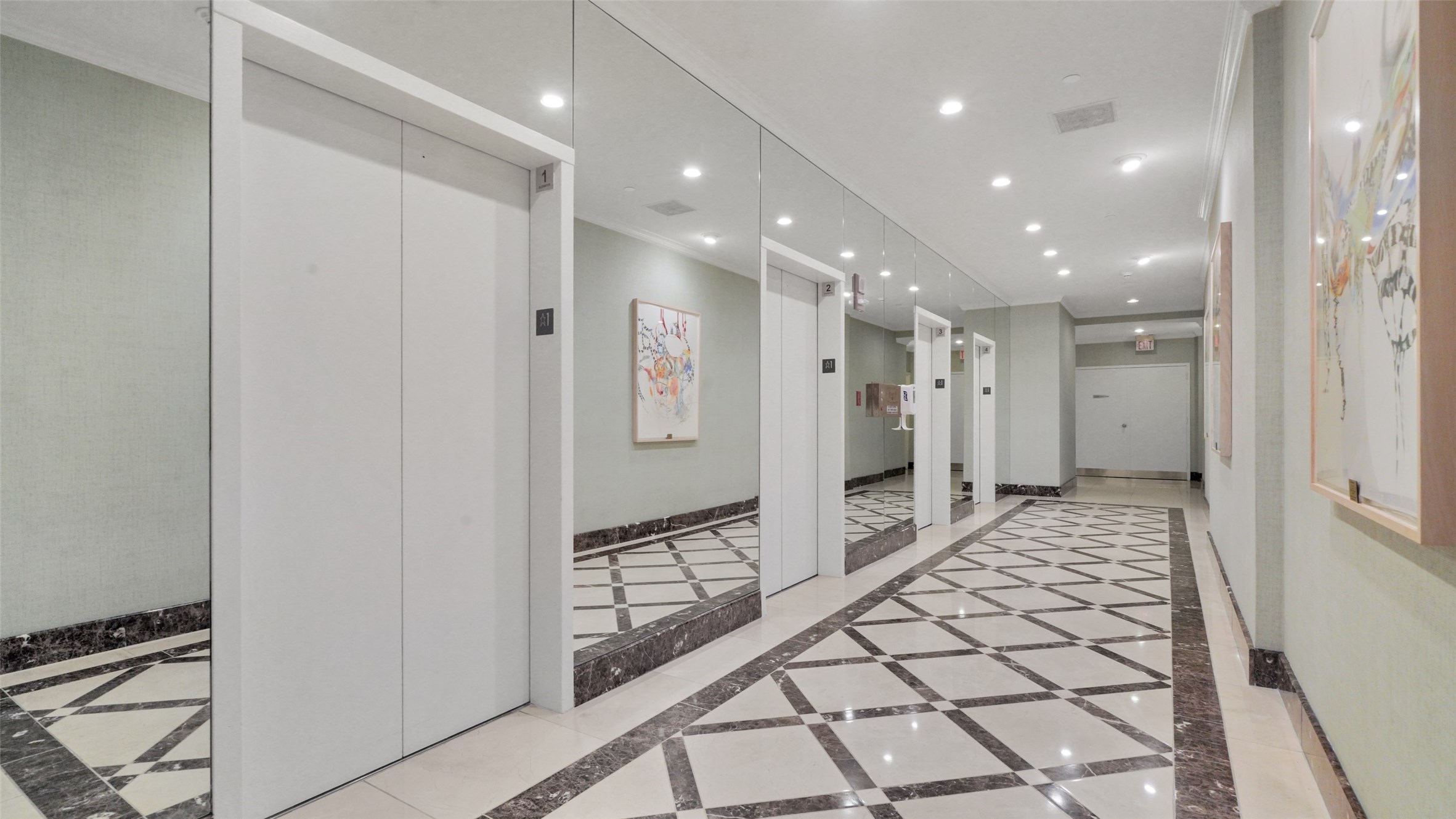 2001 Holcombe Boulevard, Unit 404 Houston, TX 77030 - Photo 21 of 33 This photo shows a sleek, modern elevator lobby with polished floors, mirrored walls, and contemporary art. The space feels bright and welcoming, ideal for a stylish residential building.
