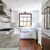 a kitchen with a sink stainless steel appliances and cabinets