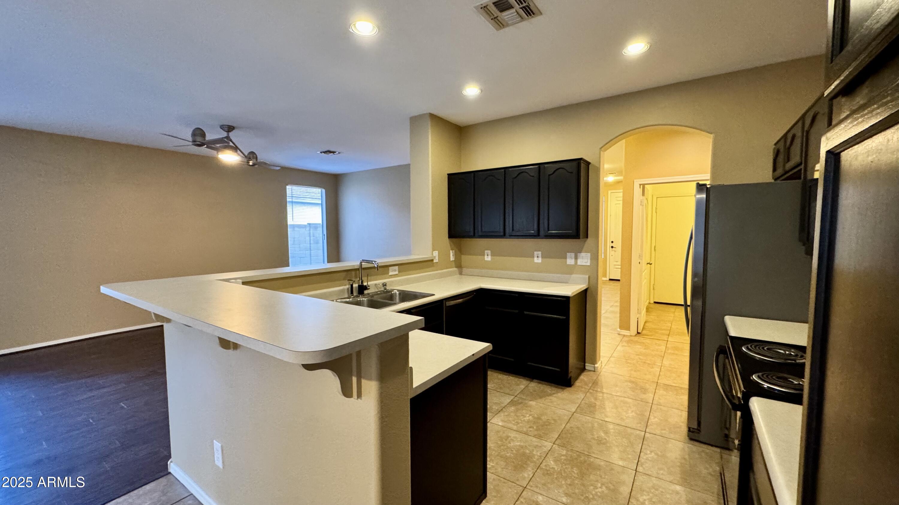 1362 W. Roadrunner Dr. Chandler, AZ 85286 - Photo 11 of 23 a kitchen with stainless steel appliances a stove refrigerator sink and microwave