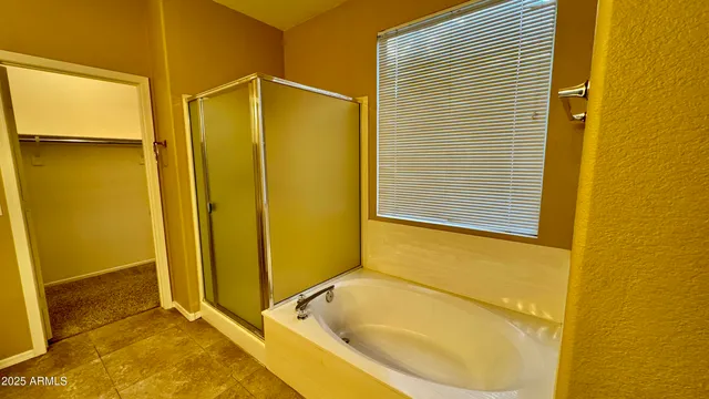 a spacious bathroom with a double vanity sink a mirror and a shower