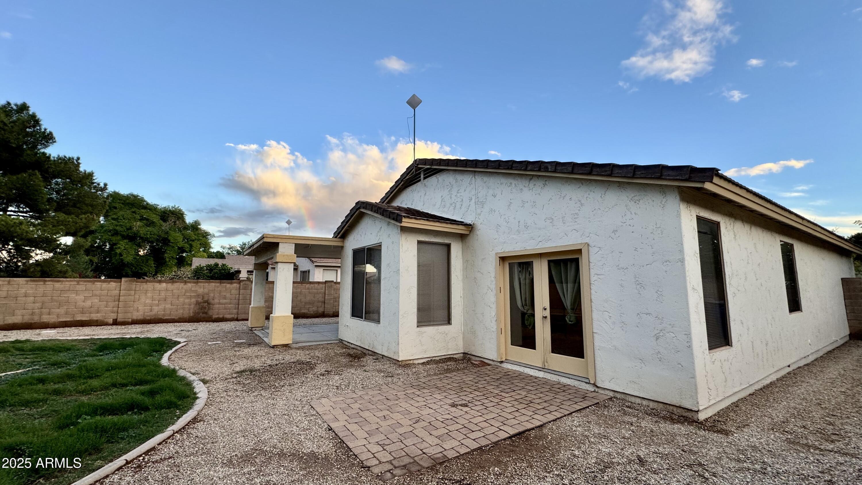 1362 W. Roadrunner Dr. Chandler, AZ 85286 - Photo 23 of 23 a yellow house with trees in front of it