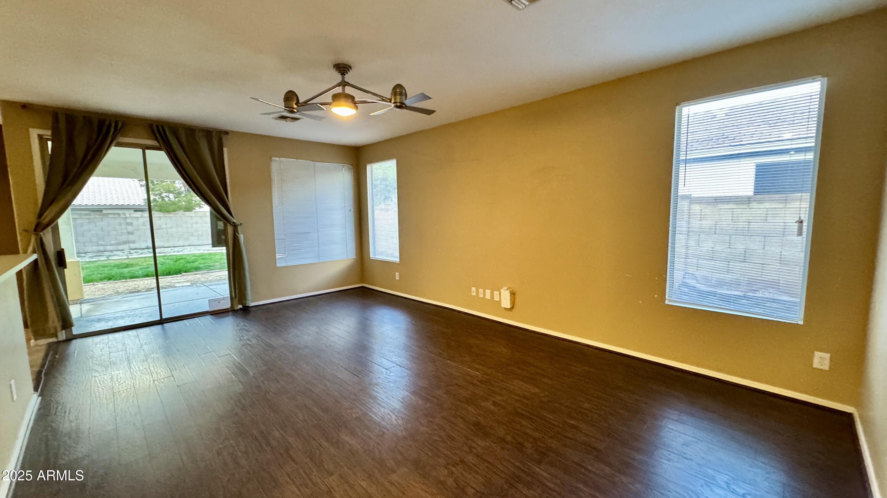 1362 W. Roadrunner Dr. Chandler, AZ 85286 - Photo 8 of 23 a view of an empty room with wooden floor and a window