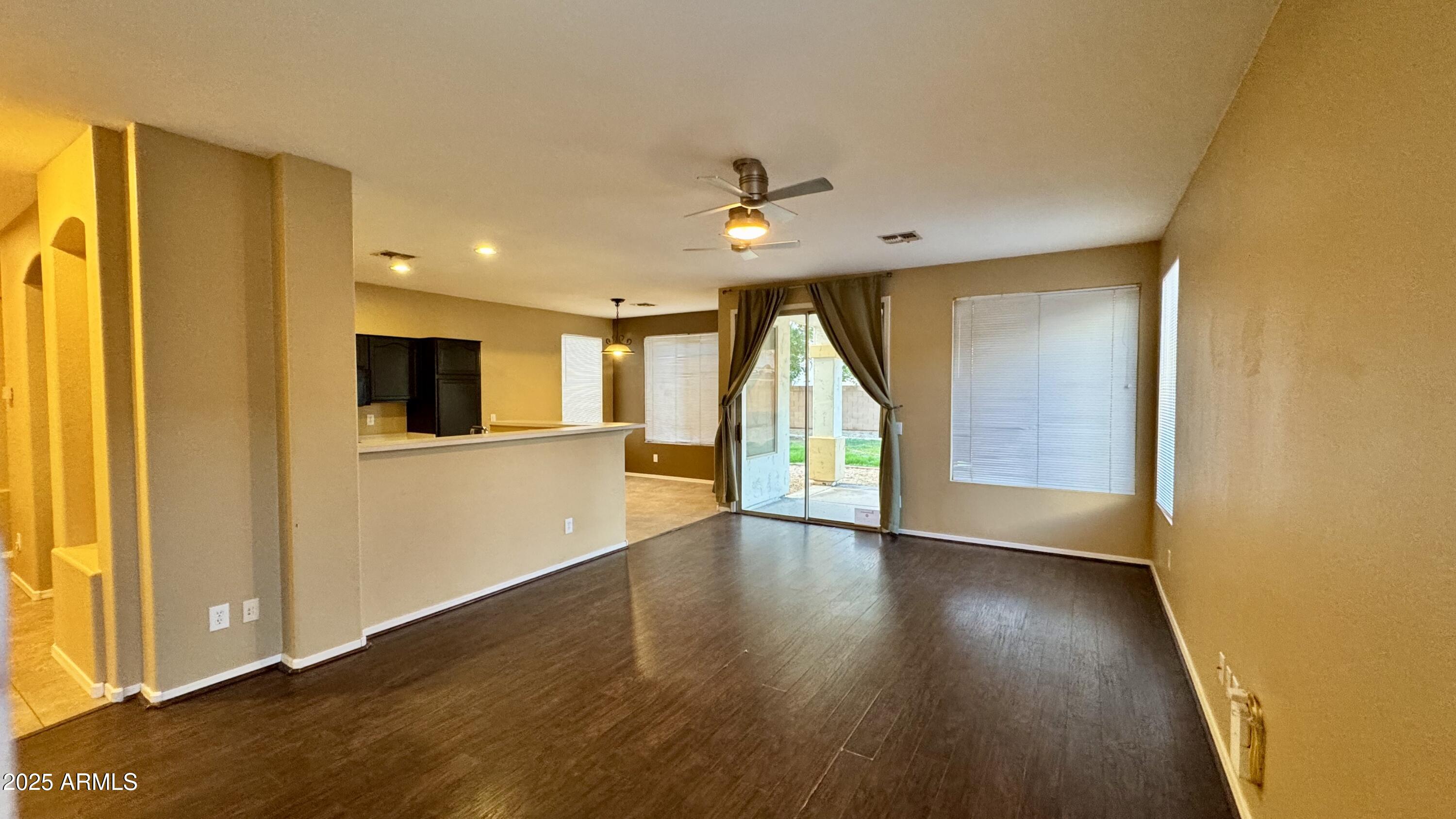 1362 W. Roadrunner Dr. Chandler, AZ 85286 - Photo 9 of 23 a view of an empty room with wooden floor and a window