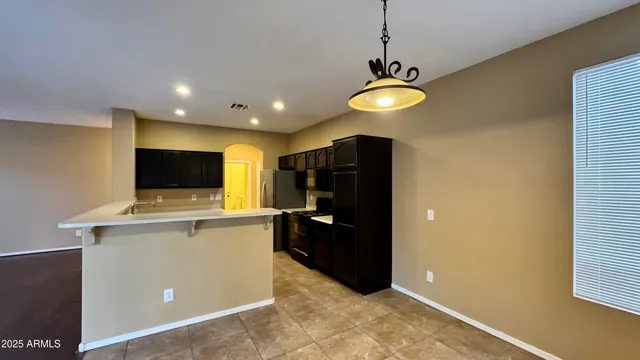 a view of a kitchen with a sink and a refrigerator