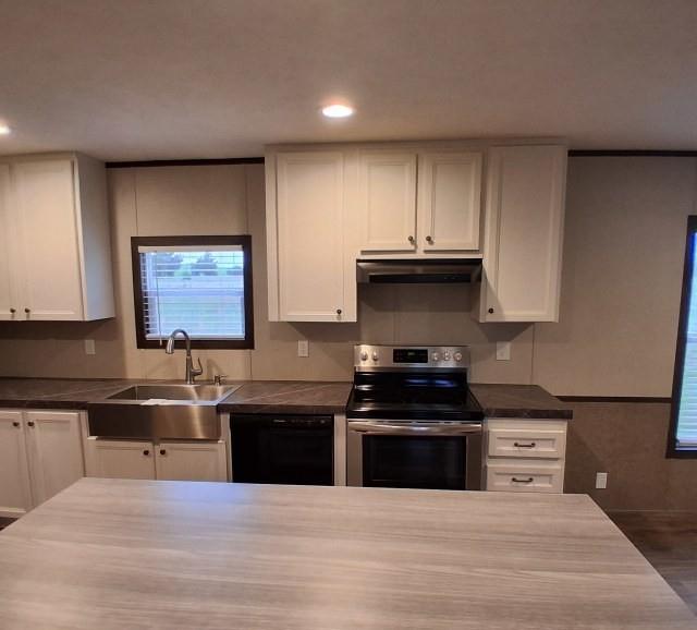 798 North 4190 Road Hugo, OK 74743 - Photo 5 of 16 a kitchen with stainless steel appliances granite countertop a stove a sink and a microwave